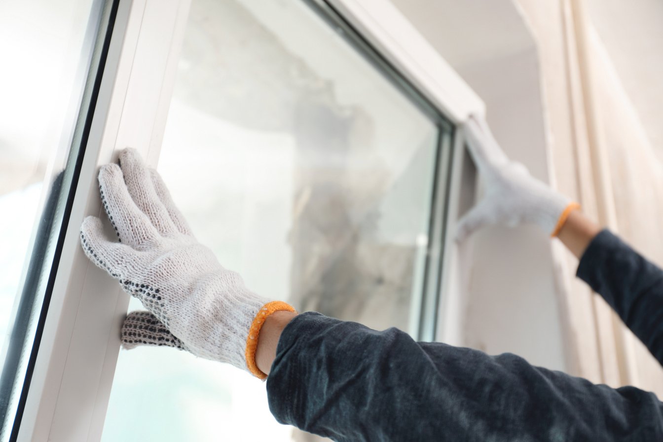 Worker Installing Plastic Window Indoors, Closeup View